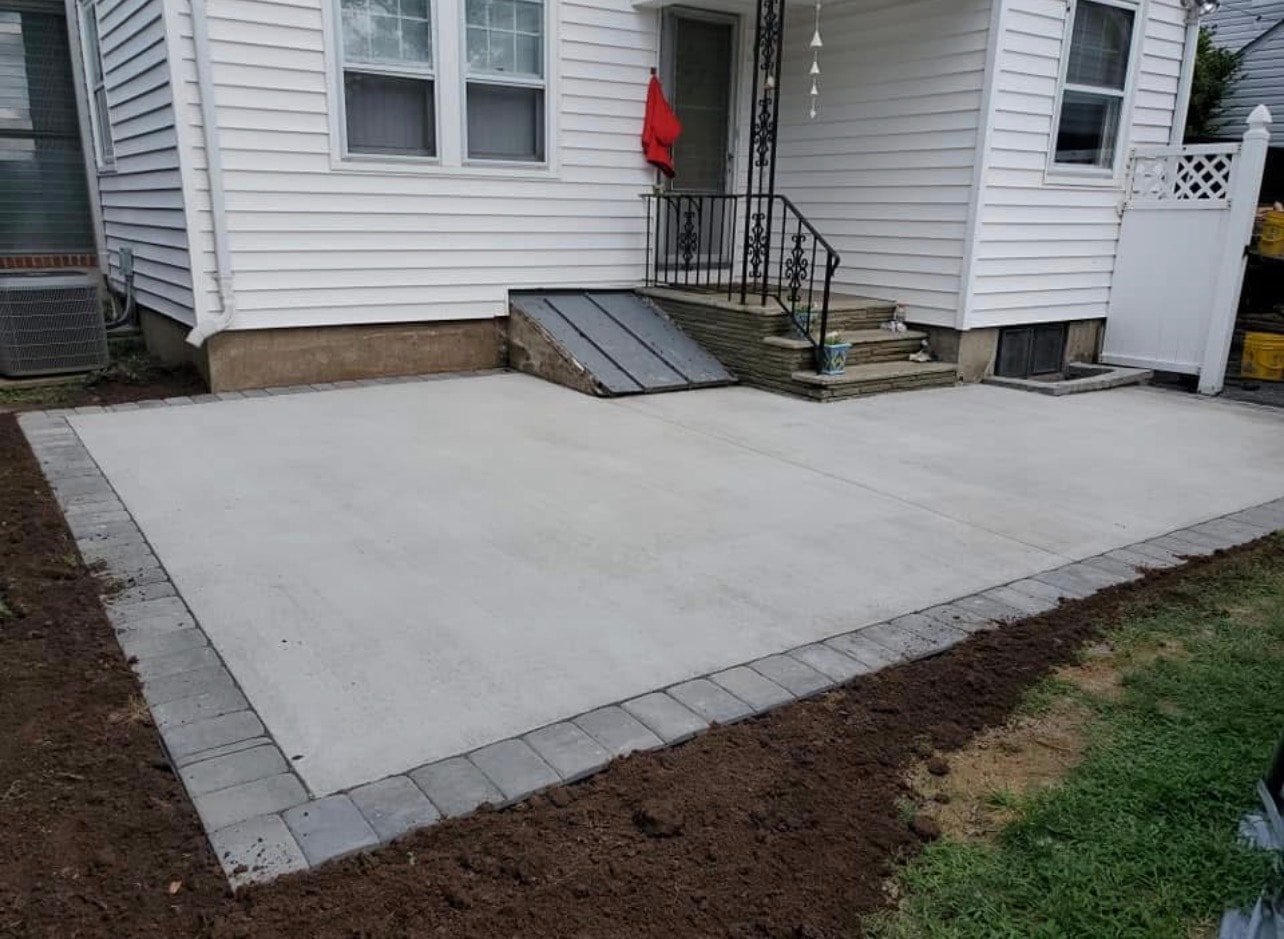 Outdoor concrete work including fire pit pad and patio